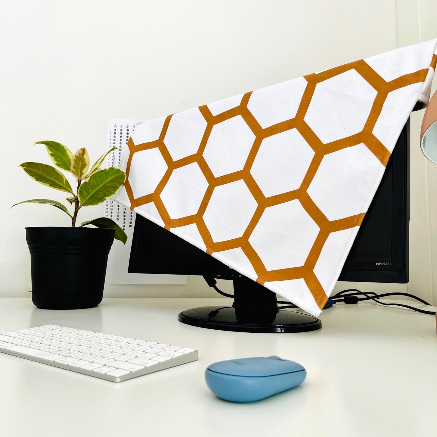gold hexagon monitor protector on a home office computer