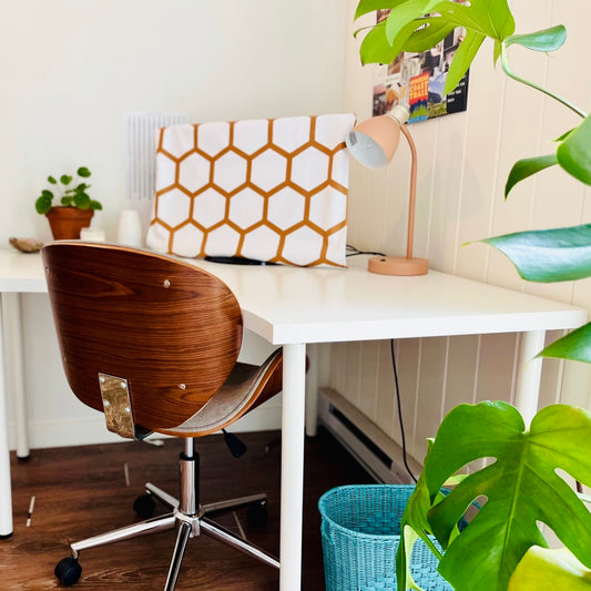 bee free gold hexagon monitor cover on home office desk