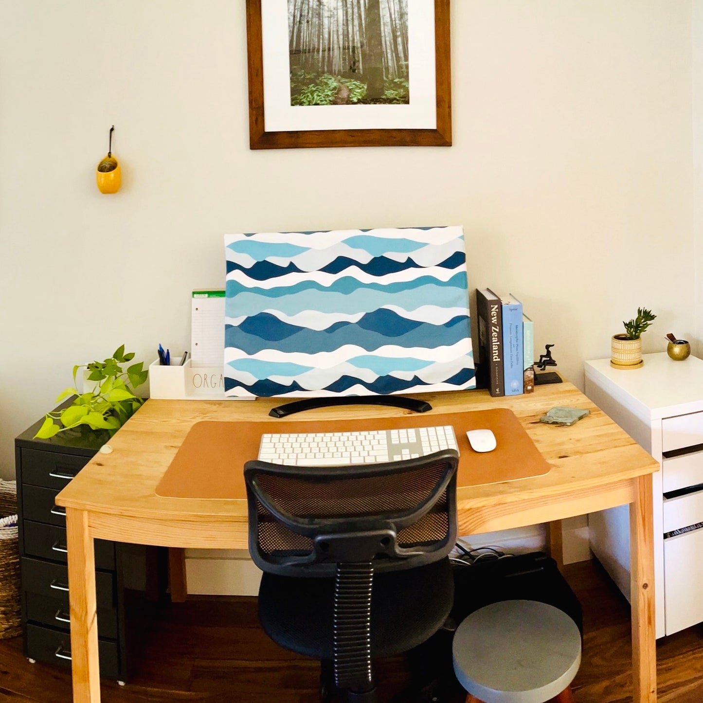 computer monitor cover hiding a computer on a home office desk